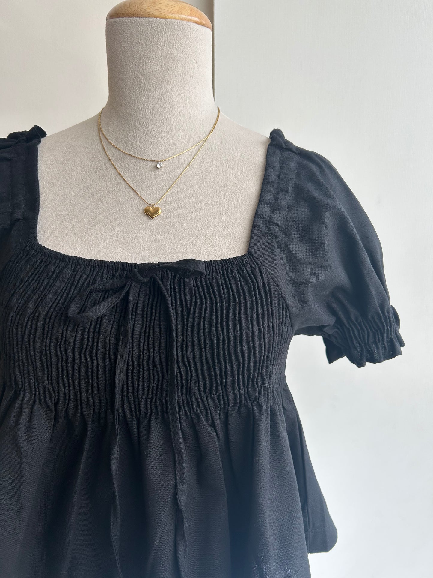 Black smocked peplum top