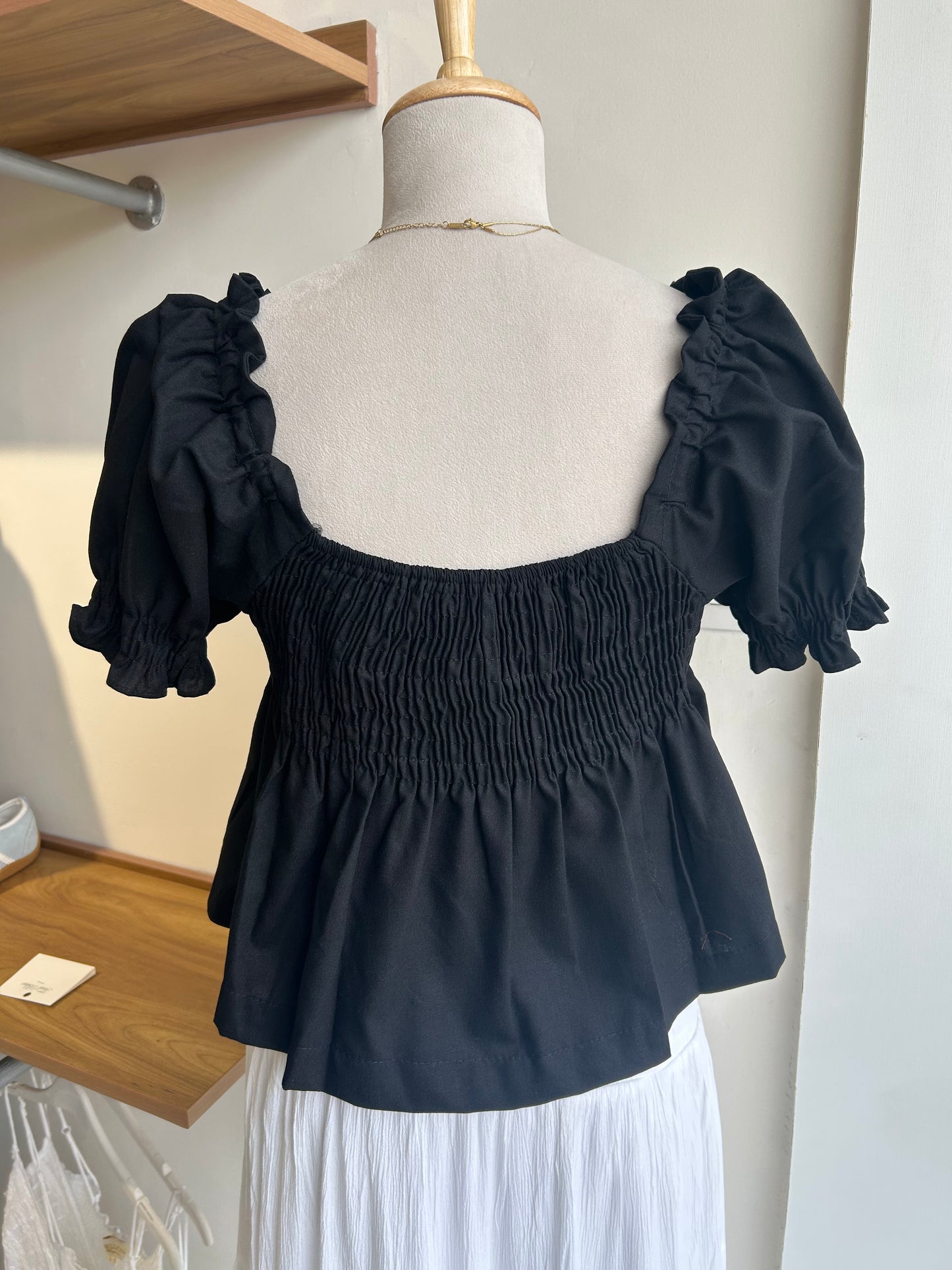 Black smocked peplum top