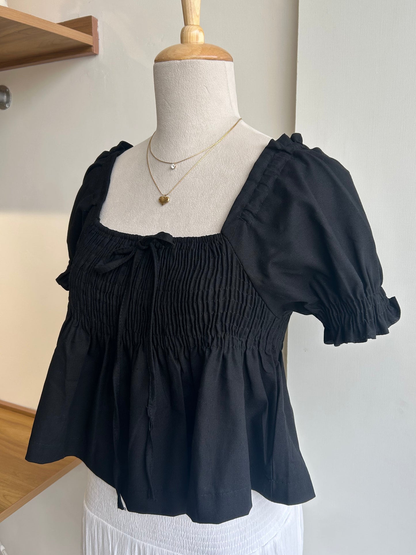 Black smocked peplum top
